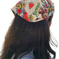 the back of a woman's head with hula girl hawaiian design bandana long hair